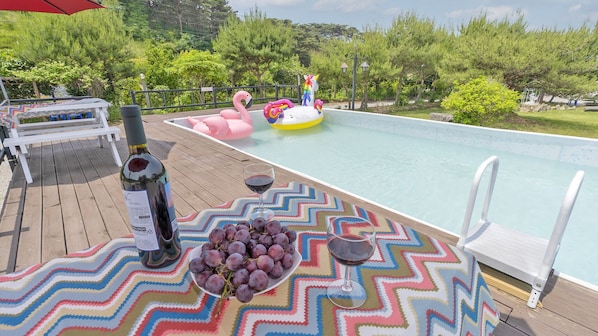 Seasonal outdoor pool, open 9:00 AM to 7:00 PM, pool umbrellas