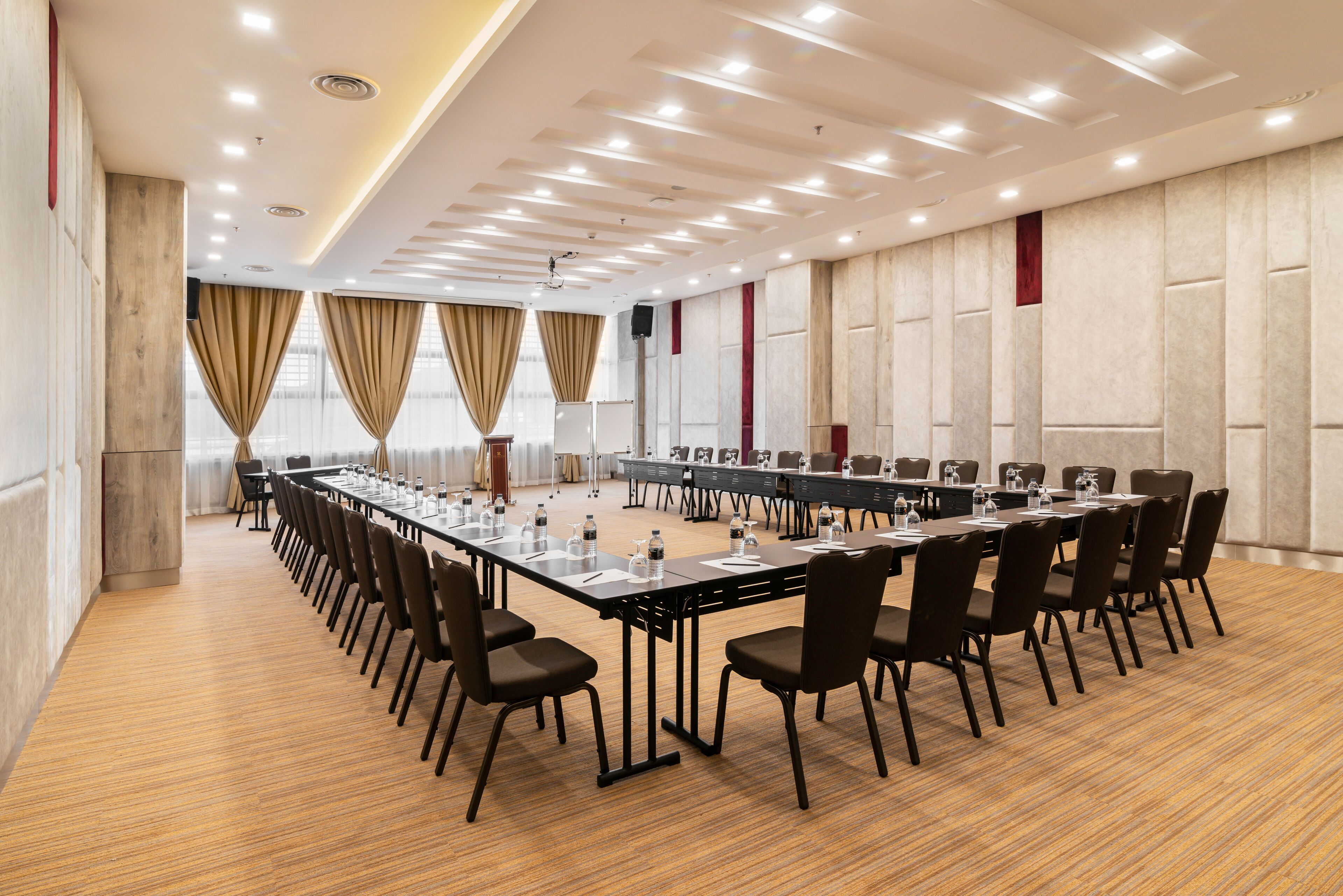 A conference room with a long table, chairs, and a projector.