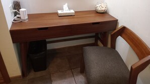 A wooden desk with a tissue box, a glass bottle, and a decorative item. - Room #6 Master with one king size bed, one double bed & one double bunk bed (La Ribera)