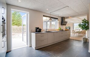 Fridge, stovetop, dishwasher, coffee/tea maker