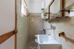 A bathroom with a bathtub, a sink, and a toilet.