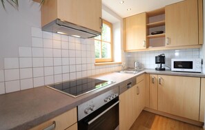 Fridge, stovetop, dishwasher, coffee/tea maker
