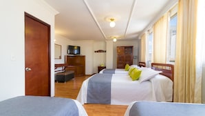 A hotel room with two beds, a TV, a desk, and a window with curtains. - Ayenda 1066 Virrey Centro (Bogotá)