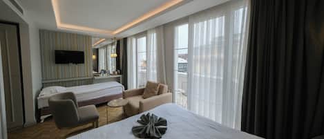 Deluxe Room, Balcony, Partial Sea View | Premium bedding, minibar, in-room safe, desk