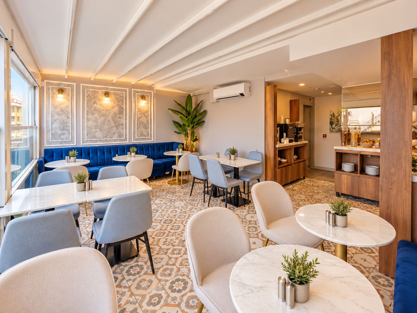 Un espace repas moderne avec des tables rondes, des sièges rembourrés en tissu bleu et un sol à motifs.