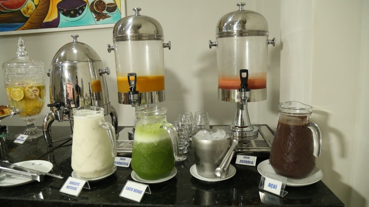A beverage station with various drinks and a coffee machine.