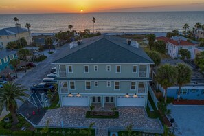 A two-story building with a flat roof, a garage, and a driveway. - ♥ OCEANFRONT VIEW ♥ BEACHFRONT CONDO ♥ NEW ♥ U3 ♥ (Indian Rocks Beach)