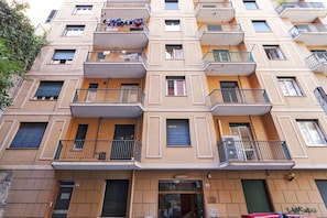 Stylish residential building with balconies and a central entrance.