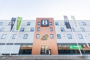 A hotel with a modern design, featuring a prominent '8' logo and 'LoP' branding on the facade. - Gr8 Hotel Maastricht-Aachen Airport (Maastricht-Airport)