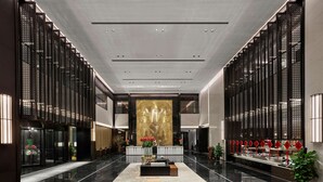 A spacious lobby with a polished marble floor, a reception desk, and decorative elements like plants and red signage. - Hilton Jiaxing (Jiaxing)