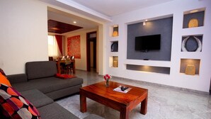 Apartment, 1 Queen Bed | Living room | 30-inch TV with digital channels - Deluxe 1- Bedroom Apartment With Swimming Pool (Kampala)