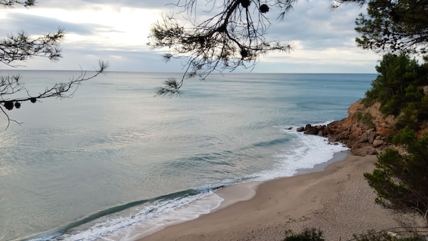 A beach with clear water, sandy shore, and rocky cliffs. - Nice and relax Mediterranean villa with free wifi  (Miami Playa)