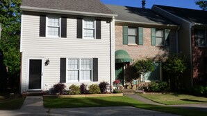 A two-story residential building with a front entrance, a covered porch, and a small front yard with a lawn and shrubs. - ***Remodeled Altadena Town Home*** Fabulous Location! (Birmingham)