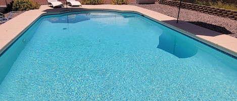 A heated pool, sun loungers