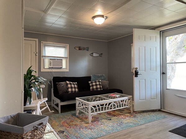 A cozy living room with a sofa, a coffee table, and a patterned rug.