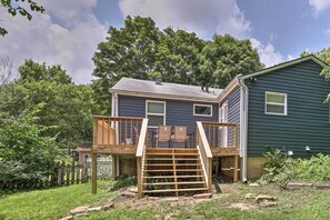 A two-story house with a wooden deck and a small staircase leading to the upper level. - Updated Fayetteville Home < 2 Miles to UArk! (Fayetteville)