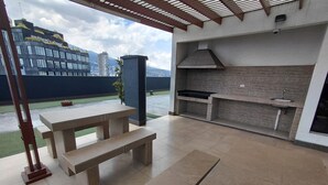 Un patio al aire libre con cocina integrada y zona de estar.