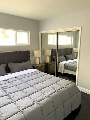 Cozy retreat with a large bed, dark headboard, and ample space to move around.