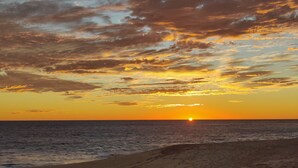 A beach with a sunset over the ocean. - Oceanfront Condo at the Copala (Cabo San Lucas)