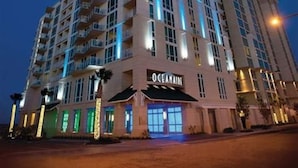 A high-rise hotel with multiple floors, balconies, and a prominent 'Oceanview' sign at the ground level. - Hilton Oceanaire Resort Escape – Oceanfront Bliss with Dual Oceanview Balconies! (Virginia Beach)