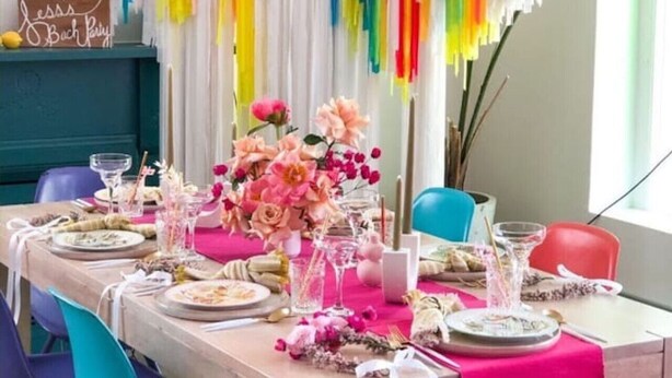 A dining area with a table set for a party, colorful drapes, and a sign that reads "Jessie's Bach Party". - Aloha 2.0 Tropical Oasis in Wicker Park Sleeps 23 with Backyard Patio (Chicago)