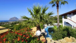 A modern villa with a pool, palm trees, and a view of the sea and mountains. - Le Palme by Interhome (Valderice)