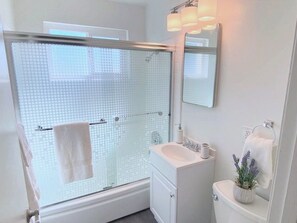 Combined shower/tub, hair dryer, towels, soap