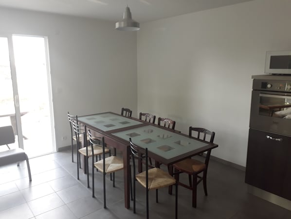 Enjoy meals in the kitchen with a central island and dining area, featuring an oven and microwave.