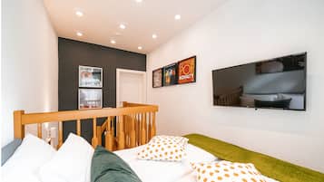 Relax in a stylish room with a comfortable bed, flat-screen TV, and artwork on the walls.