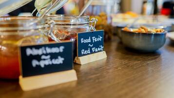 A food display with jars labeled "Nutmeg and Peppercorn" and "Red Fruit."