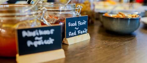 A food display with jars labeled "Nutmeg and Peppercorn" and "Red Fruit."