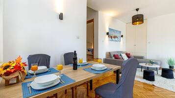 Un comedor con una mesa de madera, sillas y un cuadro en la pared.