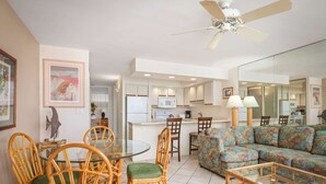A compact living space with a dining area, a sofa, and a kitchenette. - Papakea Resort - Beautiful 1 BR Ocean View Suite - NO Resort Fee (Lahaina)