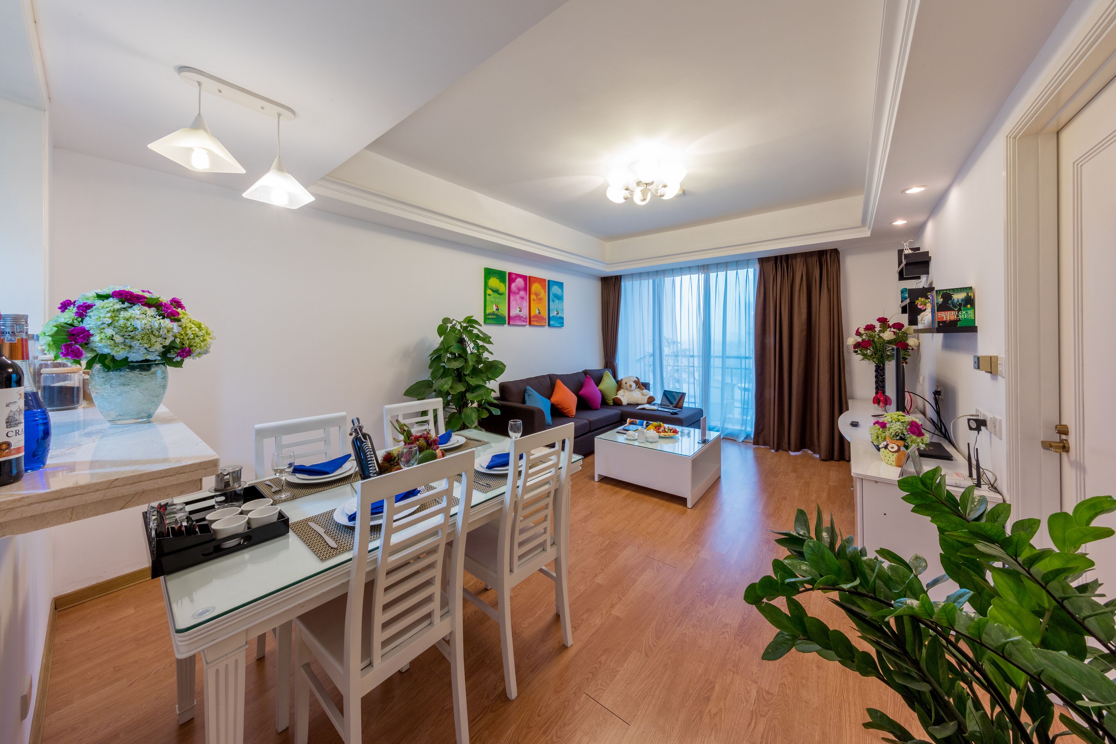 A modern living room with a dining area, a sofa, and a coffee table.