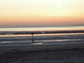 Enjoy a serene beach experience with gentle waves and a peaceful atmosphere.