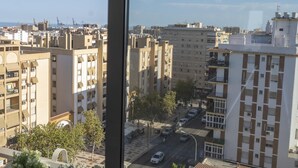 A cityscape with high-rise buildings, a clear sky, and a visible moon. - Apartamento con Balcon. Free Parking (Málaga)