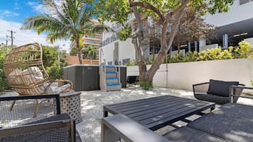 Relax in the serene outdoor patio area with a variety of seating options and lush greenery.