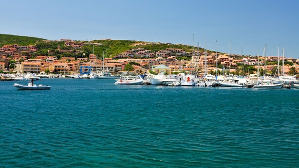 A marina with boats docked, a hillside with buildings, and a clear blue sky. - Villa Larco, Private Villa, Pool & Gardens & Stunning Views (Bassacutena)