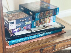 A stack of books on a wooden surface.