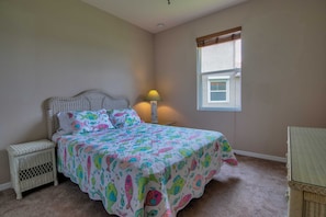 A bedroom with a bed, a nightstand, a lamp, and a window. - Fantastic Reflection Lakes Pool Home with Fabulous Views in Naples, Florida! (Naples)
