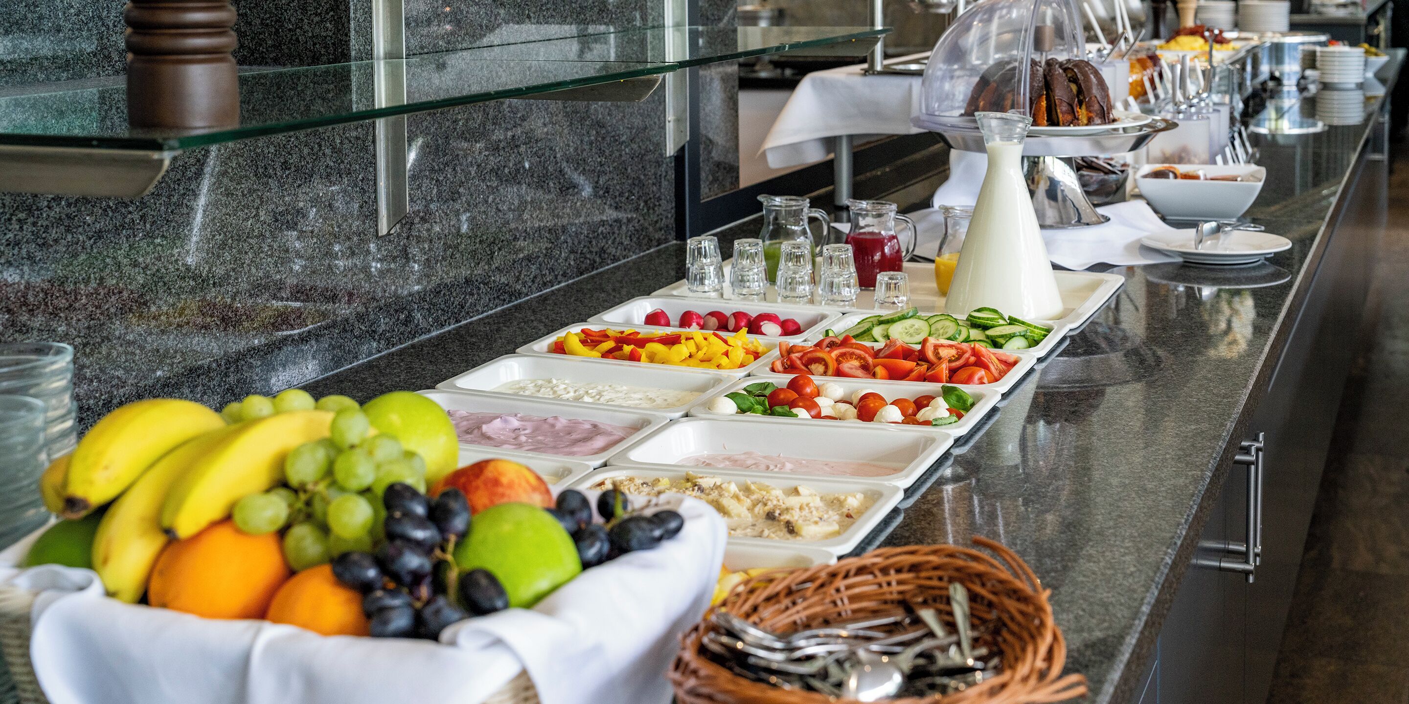 A buffet with various food items and beverages.
