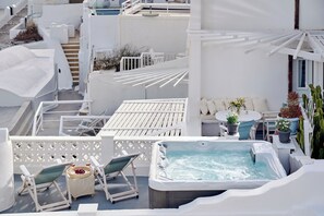 A rooftop terrace with a hot tub, lounge chairs, and potted plants. - Santorini Mansion Maisonette Sea View Jacuzzi 3BDR (Thira - Santorini)