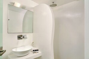 A modern bathroom with a white sink, a mirror, and a shower. - Santorini Mansion Maisonette Sea View Jacuzzi 3BDR (Thira - Santorini)
