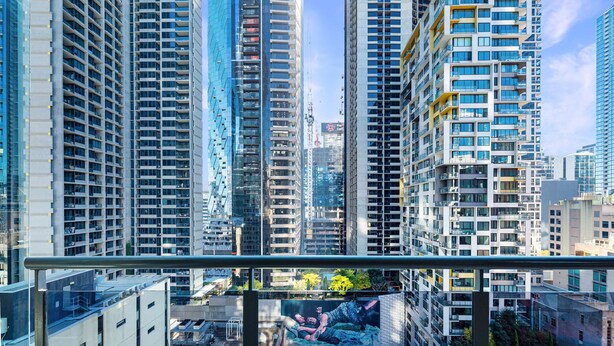 Um edifício alto com vários andares, janelas amplas e design arquitetônico moderno.