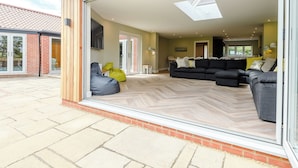 A spacious living area with a large sliding glass door leading to a patio.