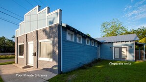 A two-story building with a private entrance and a separate unit.