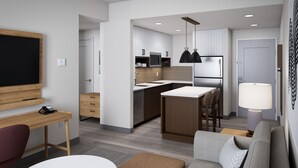 A modern kitchen with a central island, a dining area with a table and chairs, and a living area with a sofa and ottoman. - Staybridge Suites Houston NW Cypress Crossings by IHG (Houston)
