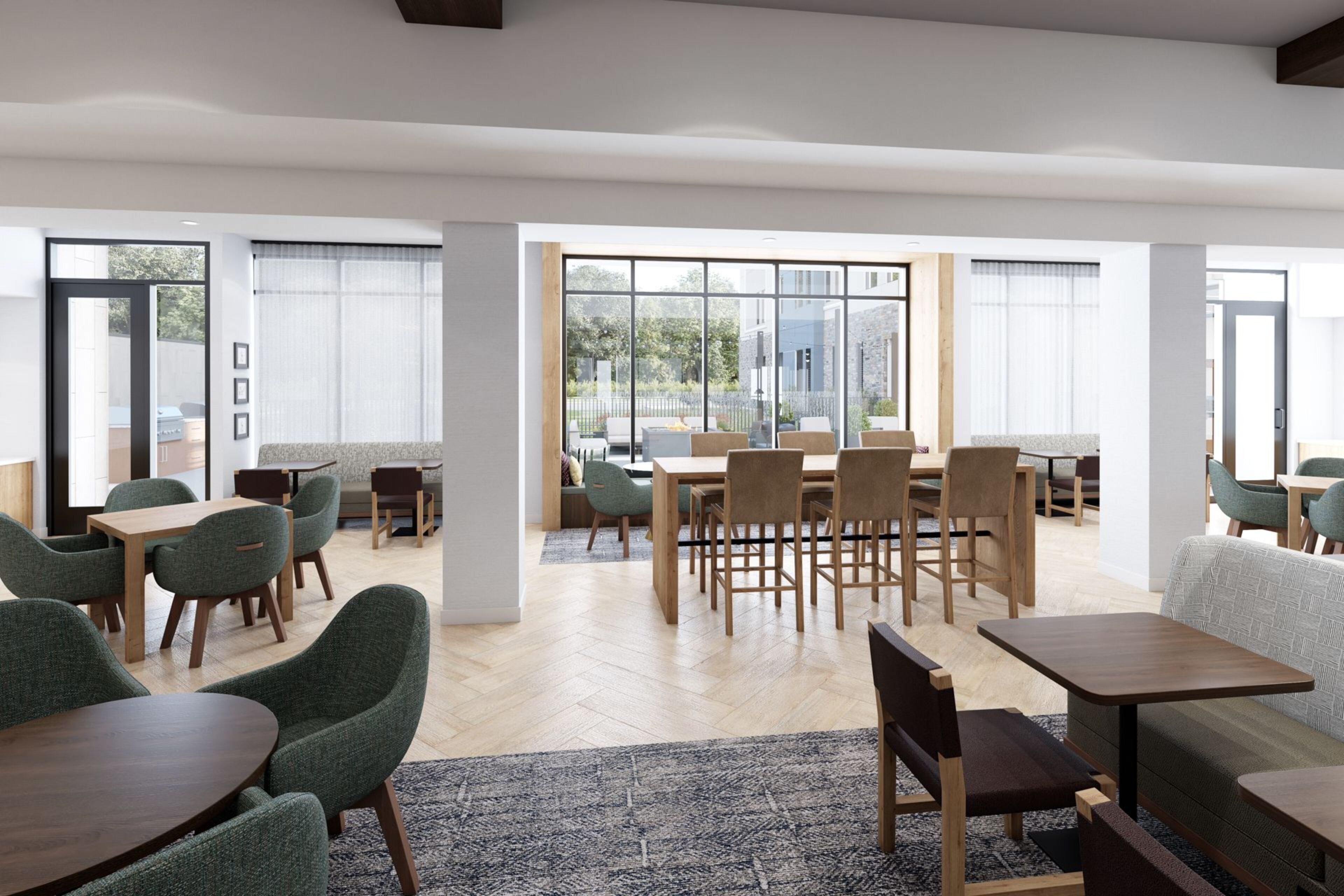 A modern interior with a dining area, seating arrangements, and large windows offering views.