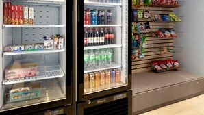 A vending machine stocked with snacks and beverages, including ice cream and soda. - Holiday Inn Express & Suites Bullhead City by IHG (Bullhead City)