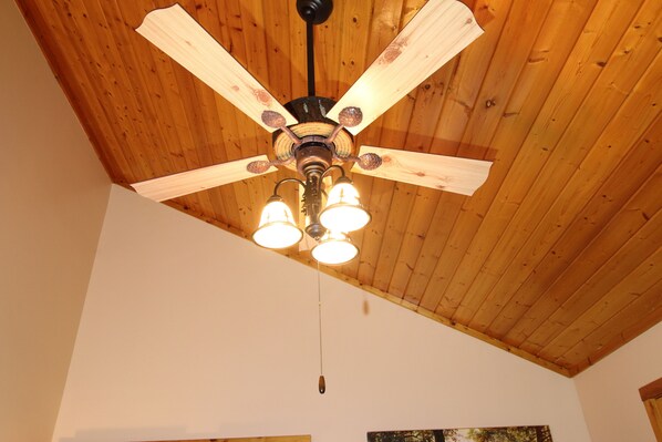 A ceiling fan with wooden blades and three light fixtures. - 360° Views! Smart cabin, EV charger, Wears Valley. 3br 2ba, hot tub. (Pigeon Forge)